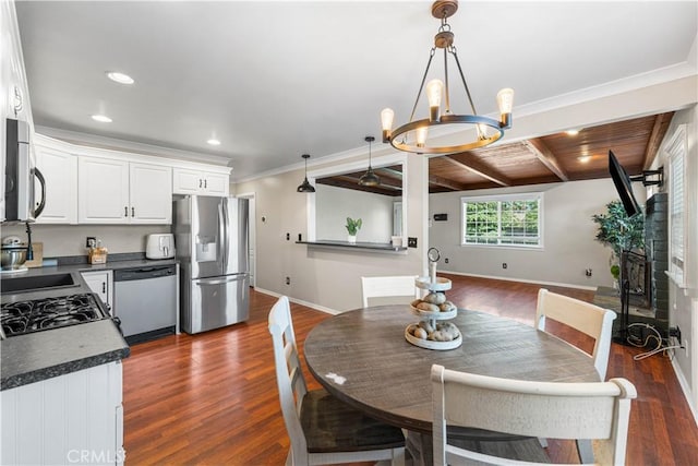 43249 42nd St W, Lancaster, CA 93536 - dining area with dark wood-style floors, recessed lighting, beamed ceiling, a chandelier, and crown molding