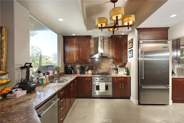 23640 Aster Trl, Calabasas, CA 91302 - kitchen featuring appliances with stainless steel finishes, wall chimney exhaust hood, backsplash, light stone counters, and recessed lighting