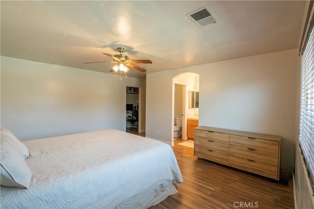 10606 Anacostia Way, Bakersfield, CA 93311 - bedroom featuring arched walkways, wood finished floors, ensuite bathroom, and ceiling fan