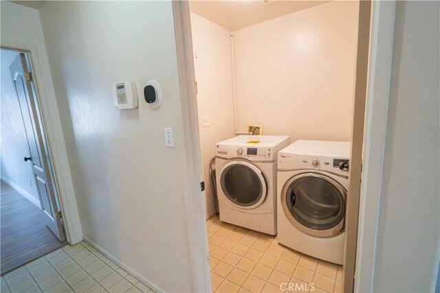 10606 Anacostia Way, Bakersfield, CA 93311 - laundry room with washing machine and dryer and light tile patterned floors