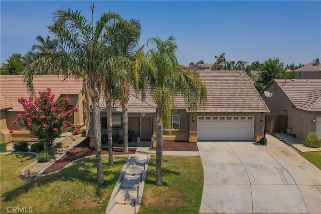 10606 Anacostia Way, Bakersfield, CA 93311 - view of front of house featuring a garage, concrete driveway, stucco siding, a front yard, and a tiled roof