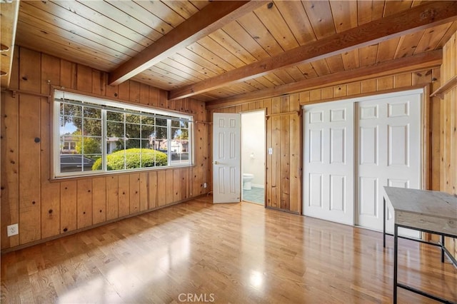 1206 E Vine Ave, West Covina, CA 91790 - unfurnished bedroom with wooden walls, a wood ceiling with exposed beams, wood finished floors, and ensuite bathroom