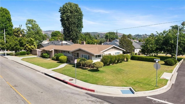 1206 E Vine Ave, West Covina, CA 91790 - ranch-style home with a front lawn, an attached garage, and driveway