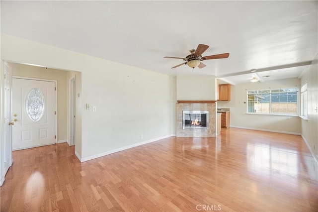 1206 E Vine Ave, West Covina, CA 91790 - unfurnished living room featuring a ceiling fan, a fireplace, and light wood finished floors