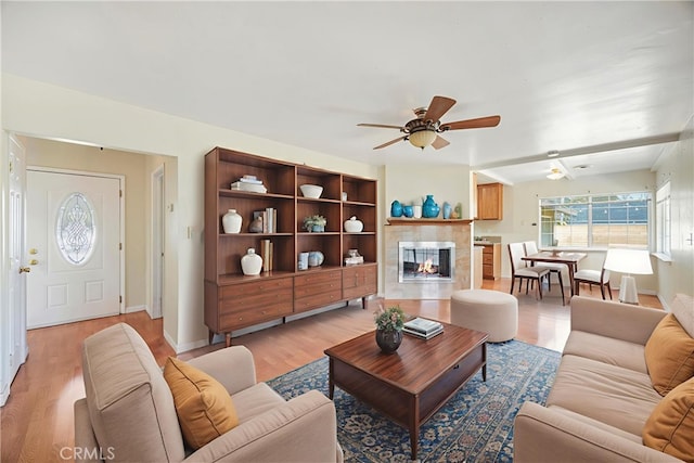 1206 E Vine Ave, West Covina, CA 91790 - living room featuring a fireplace, ceiling fan, and light wood finished floors