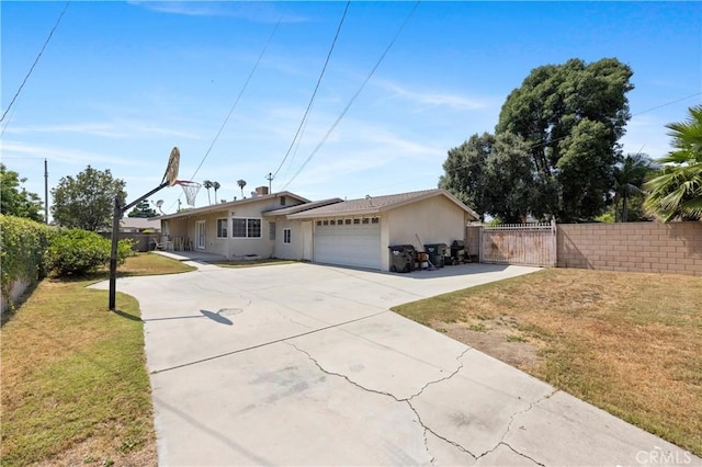 1206 E Vine Ave, West Covina, CA 91790 - ranch-style home with stucco siding, an attached garage, driveway, and a gate