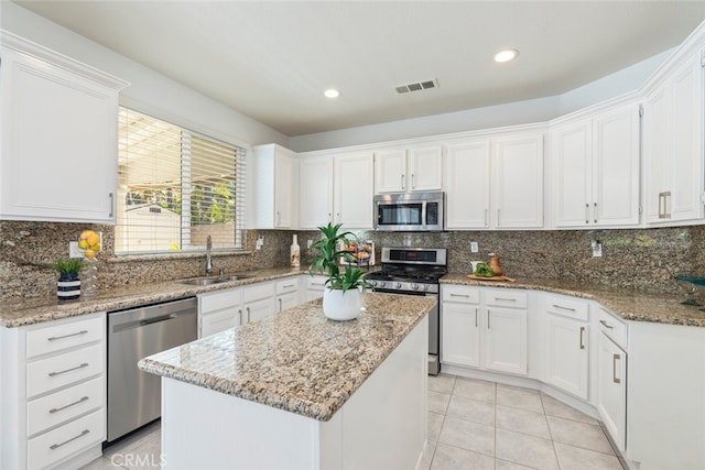 4262 Havenridge, Corona, CA 92883 - kitchen featuring stainless steel appliances, white cabinetry, a kitchen island, recessed lighting, and light tile patterned flooring
