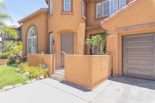 4262 Havenridge, Corona, CA 92883 - doorway to property with a gate, stucco siding, and a tiled roof