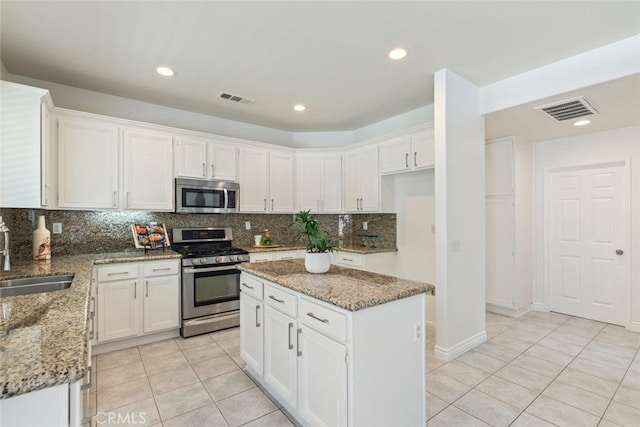 4262 Havenridge, Corona, CA 92883 - kitchen with appliances with stainless steel finishes, light tile patterned flooring, decorative backsplash, white cabinetry, and light stone counters