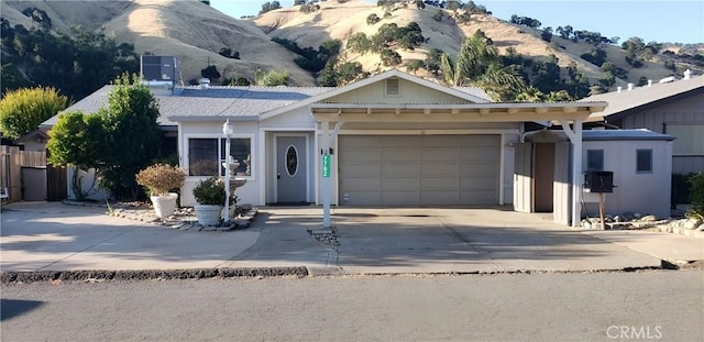 7762 Cora Dr, Lucerne, CA 95458 - single story home with a mountain view, an attached garage, and driveway