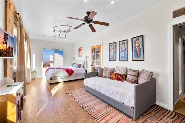 7423 Juniper Rd, Joshua Tree, CA 92252 - bedroom featuring wood finished floors, track lighting, and ceiling fan