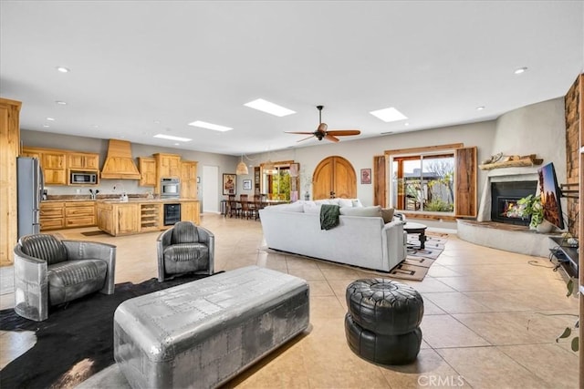 7423 Juniper Rd, Joshua Tree, CA 92252 - living room with a high end fireplace, light tile patterned flooring, ceiling fan, recessed lighting, and wine cooler