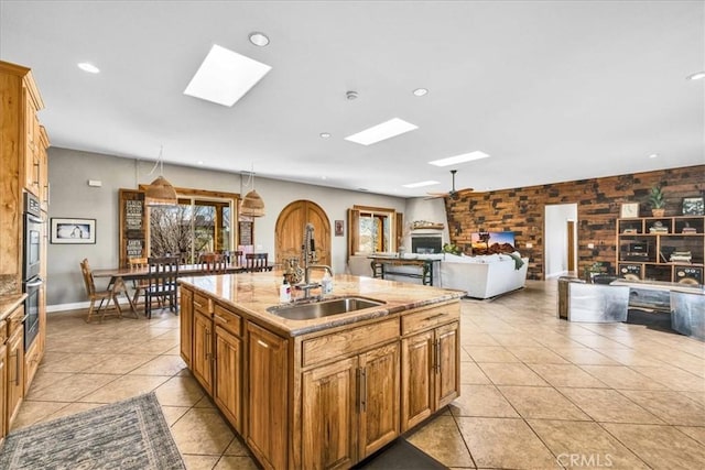 7423 Juniper Rd, Joshua Tree, CA 92252 - kitchen featuring a skylight, light tile patterned flooring, healthy amount of natural light, recessed lighting, and a kitchen island with sink