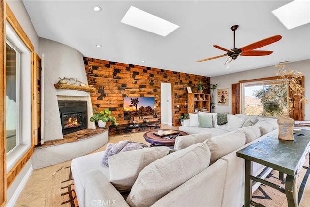 7423 Juniper Rd, Joshua Tree, CA 92252 - living room featuring a skylight, a glass covered fireplace, recessed lighting, ceiling fan, and light tile patterned floors