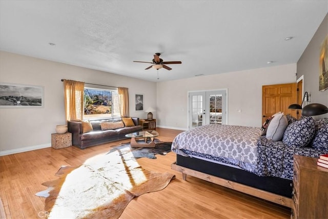 7423 Juniper Rd, Joshua Tree, CA 92252 - bedroom with multiple windows, wood finished floors, french doors, and a ceiling fan