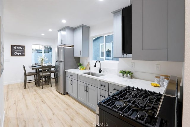 1402 E Luray St, Long Beach, CA 90807 - kitchen featuring gas stove, gray cabinetry, freestanding refrigerator, light wood-style flooring, and recessed lighting