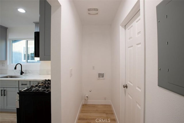 1402 E Luray St, Long Beach, CA 90807 - laundry room featuring light wood-style flooring, electric panel, hookup for a gas dryer, and recessed lighting