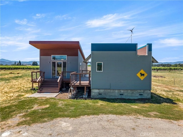 3155 Soda Bay Rd, Lakeport, CA 95453 - rear view of property with a deck with mountain view, a view of countryside, and a yard