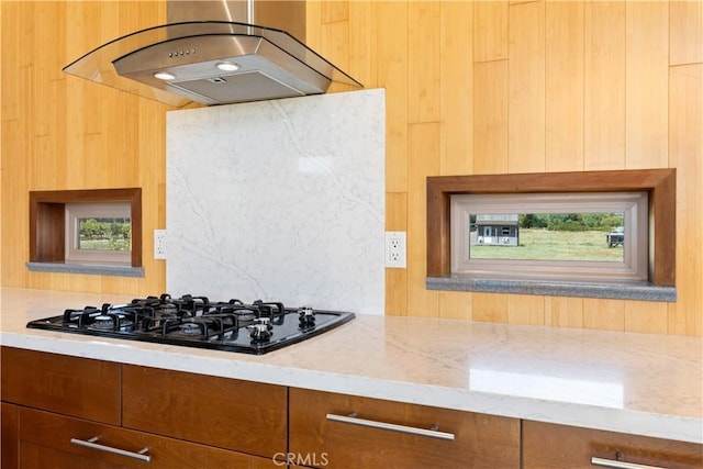 3155 Soda Bay Rd, Lakeport, CA 95453 - kitchen featuring exhaust hood, light stone countertops, plenty of natural light, and black gas stovetop