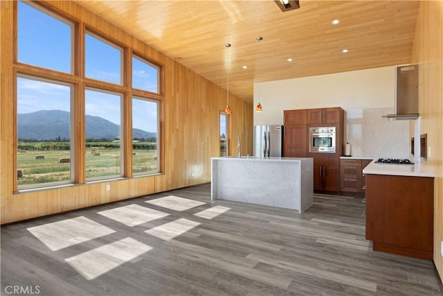 3155 Soda Bay Rd, Lakeport, CA 95453 - kitchen with wall chimney exhaust hood, a mountain view, gas stovetop, a towering ceiling, and light countertops