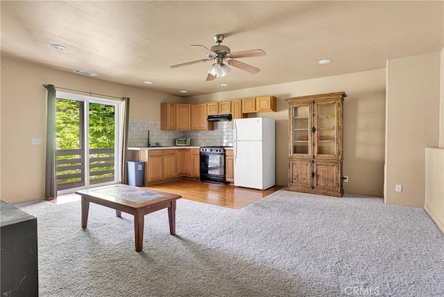 810 Oakmont Ln, Lake Arrowhead, CA 92352 - kitchen with freestanding refrigerator, black range with gas cooktop, light colored carpet, a ceiling fan, and under cabinet range hood