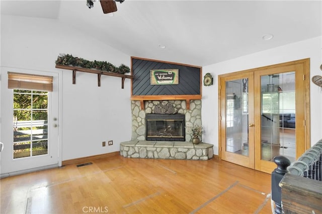 810 Oakmont Ln, Lake Arrowhead, CA 92352 - living room featuring french doors, wood finished floors, vaulted ceiling, a ceiling fan, and a fireplace