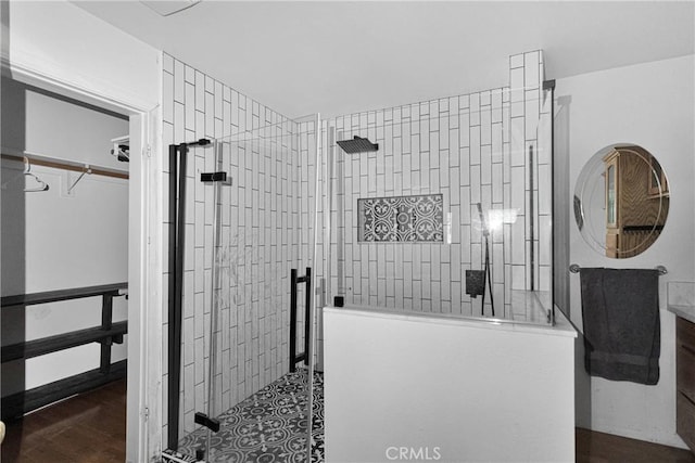 810 Oakmont Ln, Lake Arrowhead, CA 92352 - bathroom with a shower stall, a walk in closet, and wood finished floors