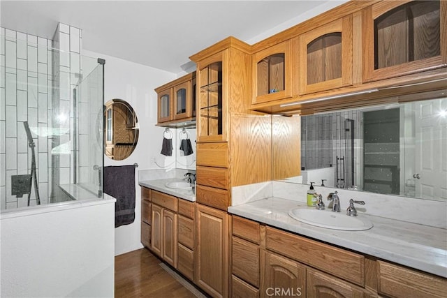 810 Oakmont Ln, Lake Arrowhead, CA 92352 - full bathroom with double vanity, tiled shower, and wood finished floors