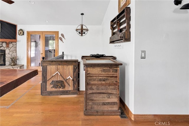 810 Oakmont Ln, Lake Arrowhead, CA 92352 - living area featuring wood finished floors, french doors, and a stone fireplace