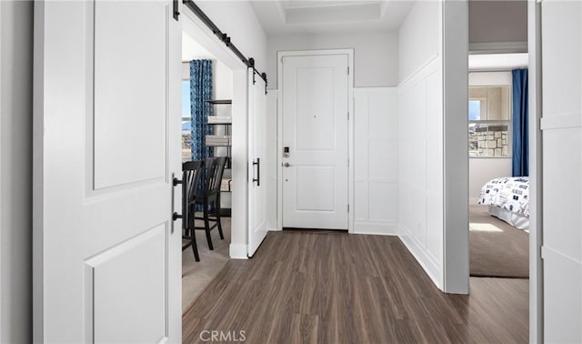 233 Carmelita Ln, Tehachapi, CA 93561 - foyer entrance featuring a barn door, dark wood-style floors, and a decorative wall