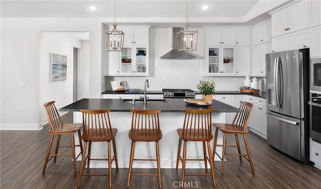 233 Carmelita Ln, Tehachapi, CA 93561 - kitchen featuring wall chimney exhaust hood, appliances with stainless steel finishes, dark countertops, dark wood finished floors, and recessed lighting