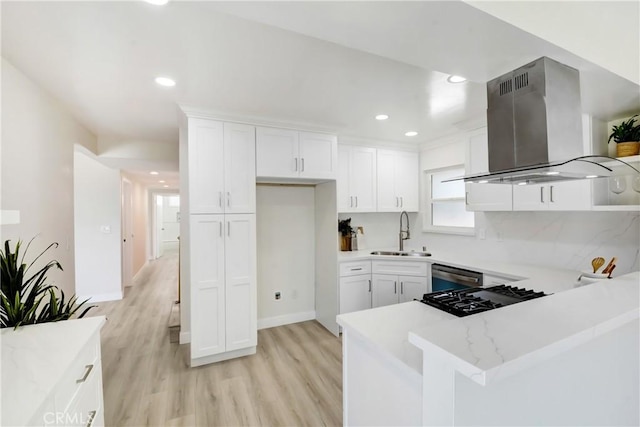 915 Bradish Ave, Glendora, CA 91740 - kitchen featuring island exhaust hood, white cabinetry, light wood-style flooring, a peninsula, and recessed lighting