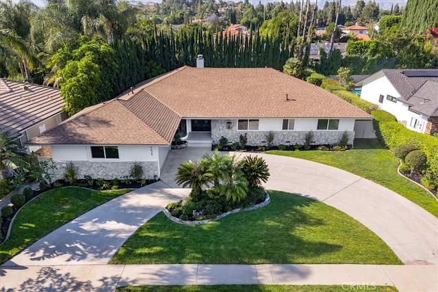 19625 Romar St, Northridge, CA 91324 - single story home with stone siding, curved driveway, a chimney, a front yard, and stucco siding