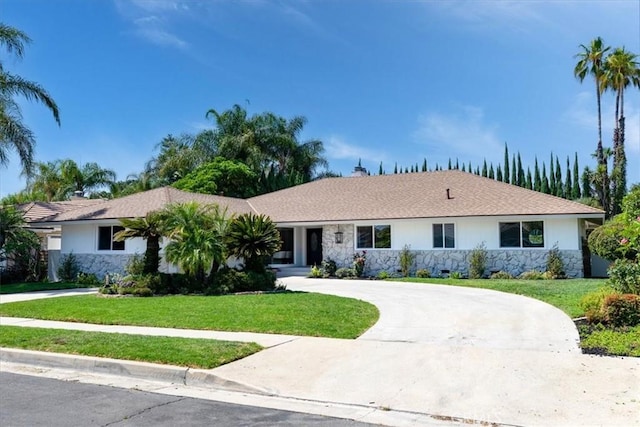 19625 Romar St, Northridge, CA 91324 - ranch-style home featuring stone siding, curved driveway, a front lawn, and stucco siding