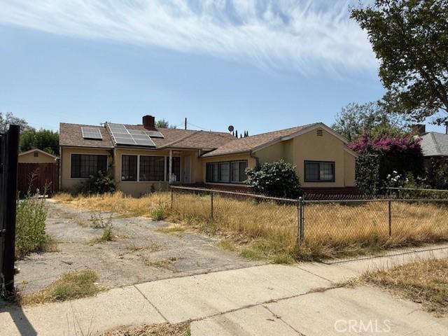 14594 Dyer St, Sylmar, CA 91342 - single story home with solar panels, stucco siding, a chimney, and driveway