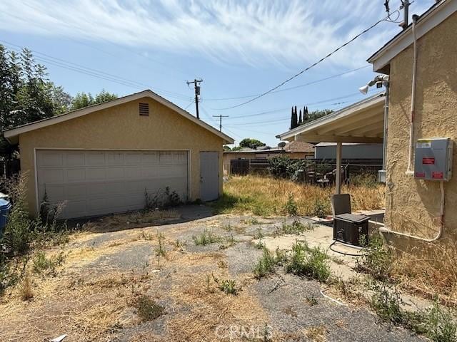 14594 Dyer St, Sylmar, CA 91342 - view of home's exterior with stucco siding, a detached garage, and an outbuilding
