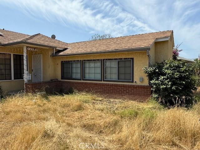 14594 Dyer St, Sylmar, CA 91342 - view of home's exterior with brick siding, stucco siding, and a shingled roof
