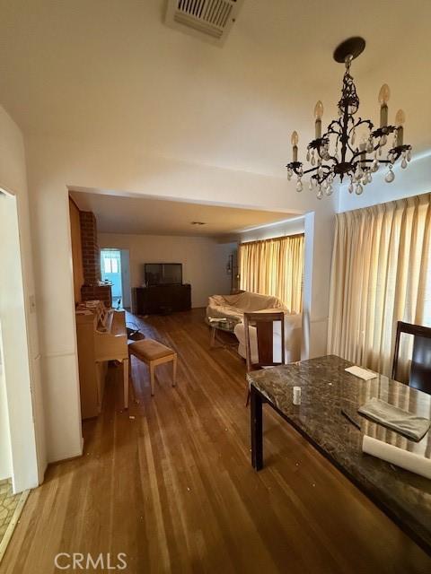 14594 Dyer St, Sylmar, CA 91342 - interior space featuring wood finished floors and a chandelier