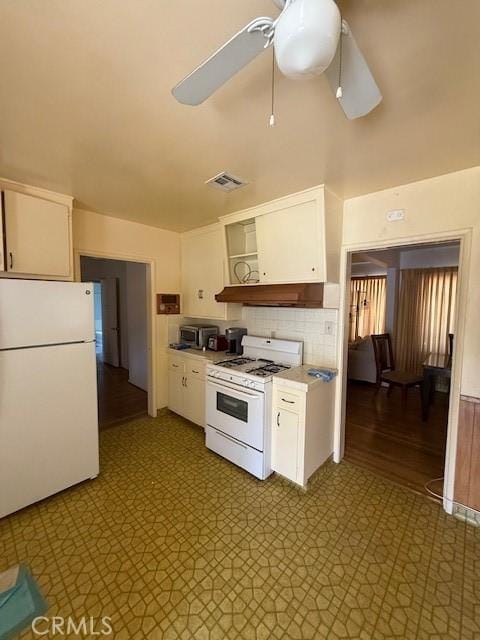 14594 Dyer St, Sylmar, CA 91342 - kitchen with white appliances, under cabinet range hood, and white cabinetry