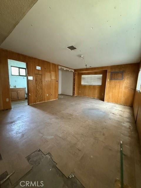 14594 Dyer St, Sylmar, CA 91342 - unfurnished living room featuring wooden walls and plenty of natural light