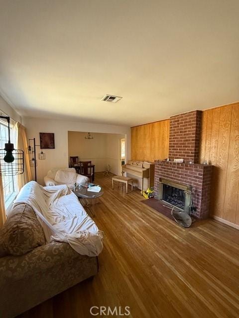 14594 Dyer St, Sylmar, CA 91342 - living room featuring wood finished floors and a brick fireplace