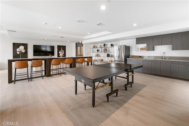 168 S Monterey St Unit 502, Alhambra, CA 91801 - recreation room featuring light wood-style flooring, a community bar, recessed lighting, and a raised ceiling