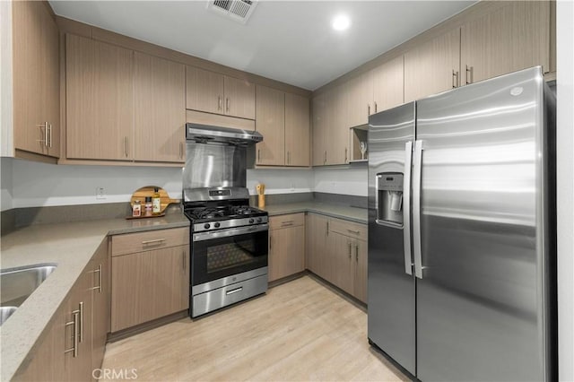 168 S Monterey St Unit 502, Alhambra, CA 91801 - kitchen featuring stainless steel appliances, under cabinet range hood, light wood-style floors, dark stone countertops, and recessed lighting
