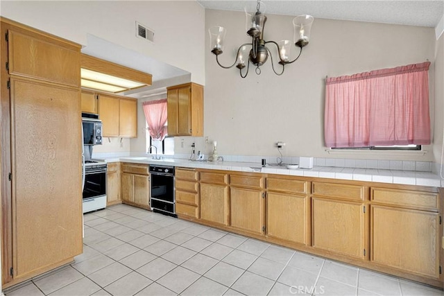 16205 Tokay St, Victorville, CA 92395 - kitchen with white range oven, a chandelier, light tile patterned flooring, black dishwasher, and light countertops