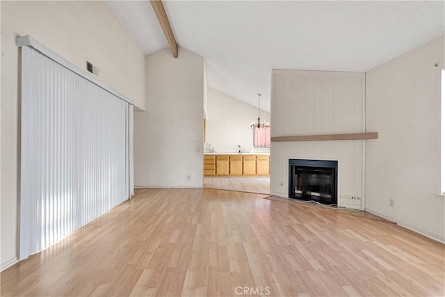 16205 Tokay St, Victorville, CA 92395 - unfurnished living room with light wood-style flooring, beamed ceiling, a chandelier, a fireplace, and high vaulted ceiling