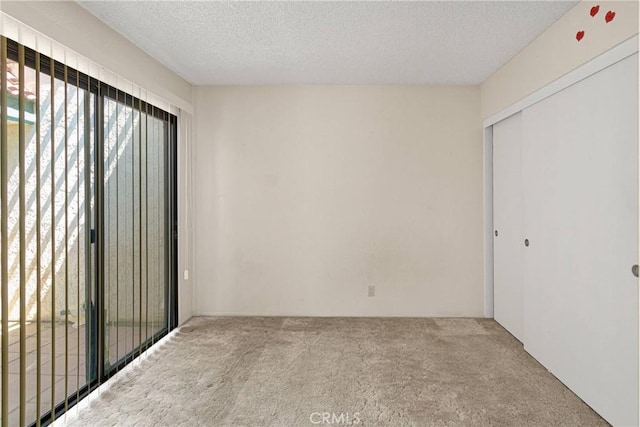 16205 Tokay St, Victorville, CA 92395 - unfurnished bedroom with carpet, a textured ceiling, and a closet