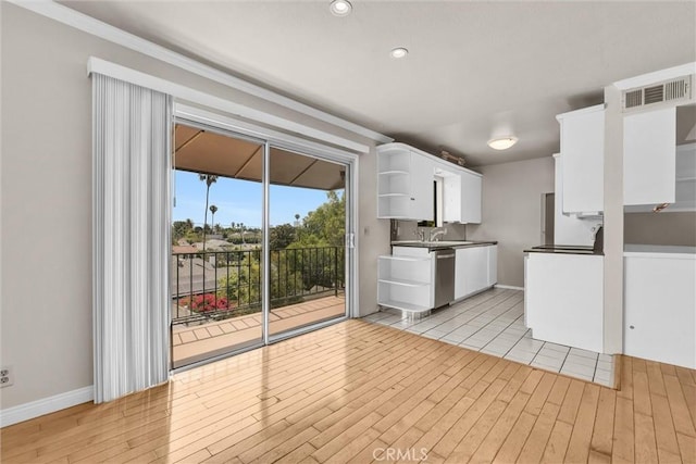 532 N Rossmore Ave Unit 411, Los Angeles, CA 90004 - kitchen with open shelves, white cabinetry, light wood-type flooring, stainless steel dishwasher, and recessed lighting