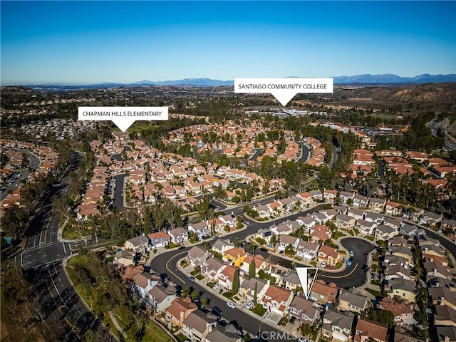 8507 E Heatherview Ln, Orange, CA 92869 - aerial view of property's location featuring a mountainous background and nearby suburban area