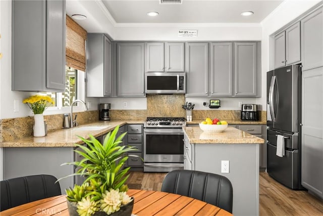 8507 E Heatherview Ln, Orange, CA 92869 - kitchen featuring stainless steel appliances, gray cabinetry, wood finished floors, recessed lighting, and a center island