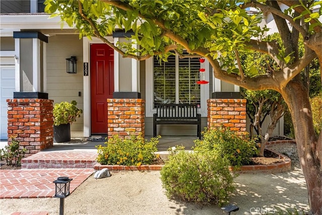 8507 E Heatherview Ln, Orange, CA 92869 - doorway to property featuring brick siding and covered porch
